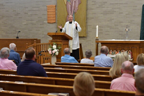 Fr. John speaking from the altar at St. Elizabeth Ann Seton Church.